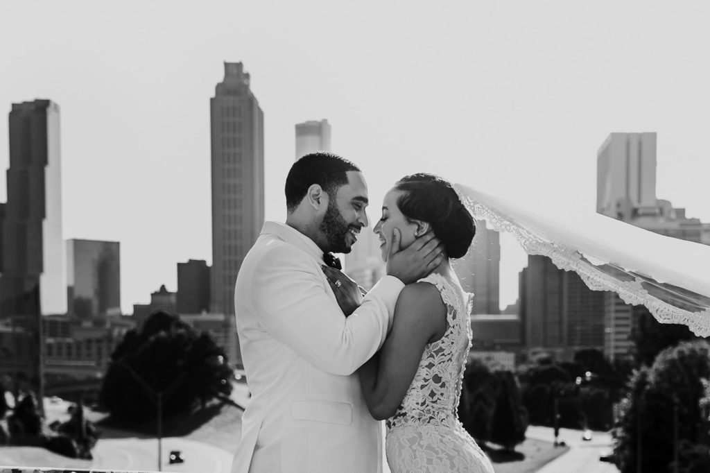 Bride and Groom in front of Downtown Atlanta Skyline view at Jackson Bridge | Photo by Meli and Chris Atlanta Based destination Wedding Photography. 