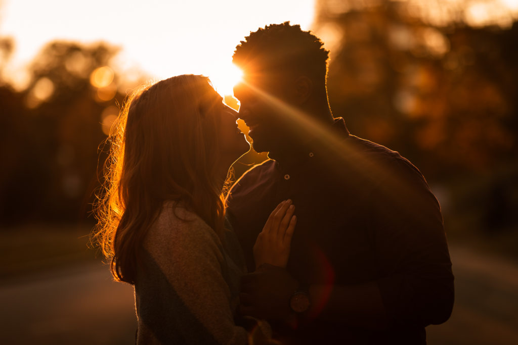 Couple hugging during sunset at Midtown Atlanta | Sunflare at Piedmont Park | Photo by Meli and Chris Wedding Photography