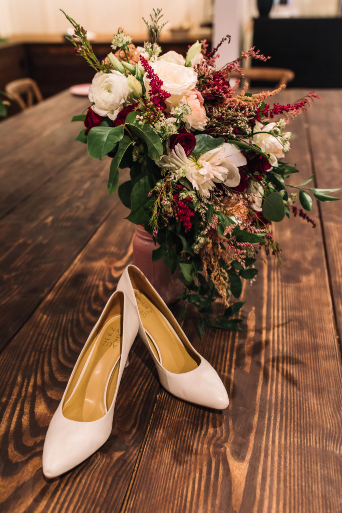 Bridal shoes and bouquet. Photo by Meli and Chris Wedding Photography.