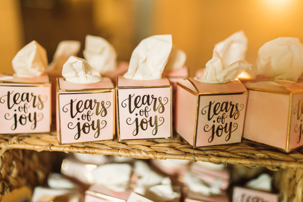 Tiny party favors for wedding guests that say "Tears of Joy" with a tissue popping out. Photo by Meli and Chris Wedding Photography atlweddingphotos.com